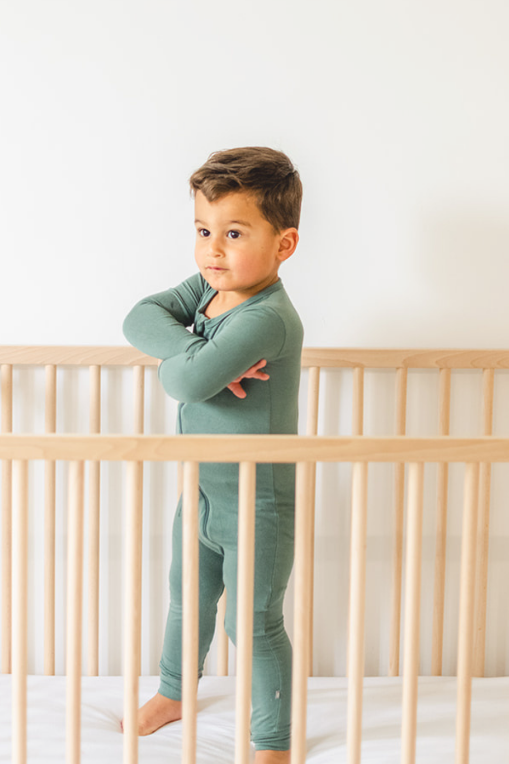 Toddler standing in his crib protesting his nap.
